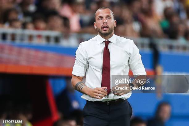 Assistant coach, John Heitinga of Ajax U19 directs his players during their friendly match between FC Barcelona U19 and Ajax U19 at the new Johan...