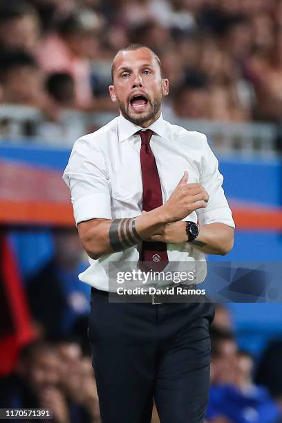 Assistant coach, John Heitinga of Ajax U19 directs his players during their friendly match between FC Barcelona U19 and Ajax U19 at the new Johan...