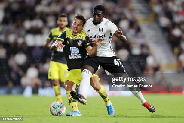 Cedric Soares of Southampton and Aboubakar Kamara of Fulham battle for possession during the Carabao Cup Second Round match between Fulham and...