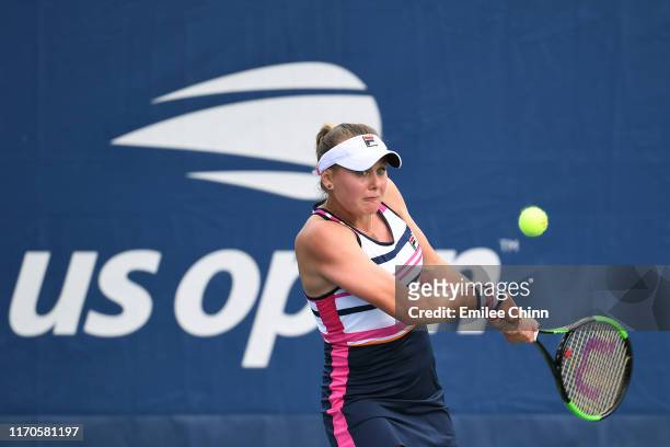Kateryna Kozlova of the of the Ukraine returns a shot against Taylor Townsend of the United States during their Women's Singles first round match on...