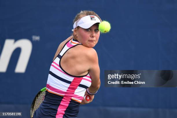 Kateryna Kozlova of the of the Ukraine returns a shot against Taylor Townsend of the United States during their Women's Singles first round match on...