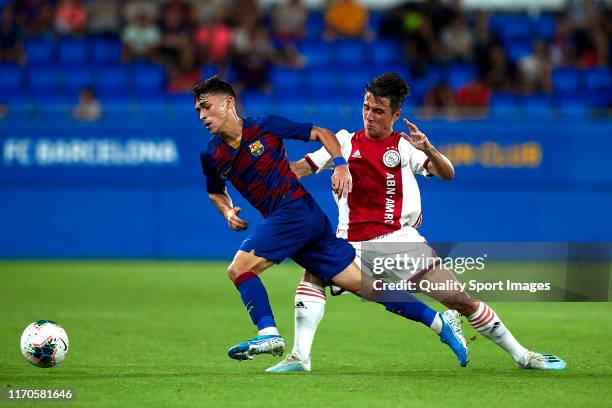 Adria Altamira of FC Barcelona U19 competes for the ball with