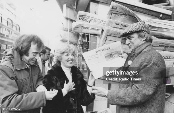 Comedians Chris Emmett, Janet Brown and Roy Hudd at a news stand, for the BBC Radio 2 sketch show 'The News Huddlines', 1975.