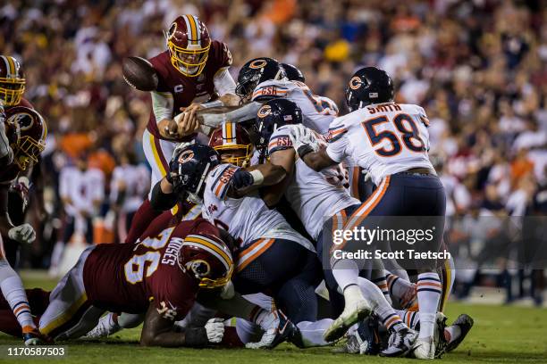 Case Keenum of the Washington Redskins gets the ball punched out of his hands against the Chicago Bears during the second half at FedExField on...