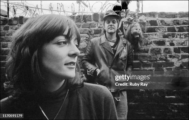 British performance artist and musician Cosey Fanni Tutti, holding a small dog, and British singer-songwriter and musician Genesis P-Orridge , of...
