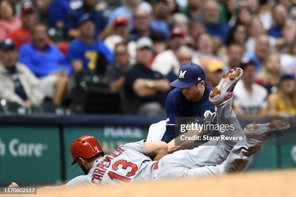 Matt Carpenter of the St. Louis Cardinals is tagged out at third base by Cory Spangenberg of the Milwaukee Brewers during the fifth inning at Miller...
