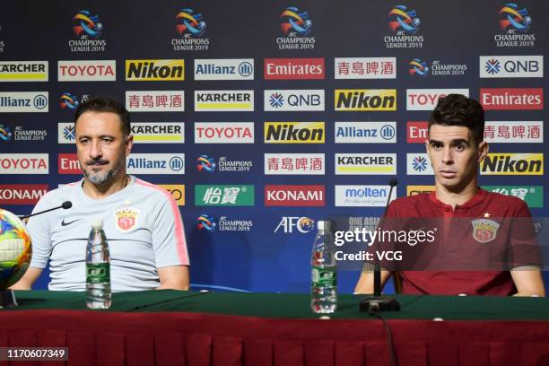 Head coach Vitor Pereira and Oscar of Shanghai SIPG attend a press conference after the AFC Champions League quarter-final 1st leg match between...