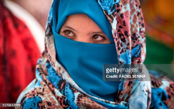 Young Amazigh woman waits for her wedding ceremony during the annual "Engagement Moussem" festival near the village of Imilchil in central Morocco's...
