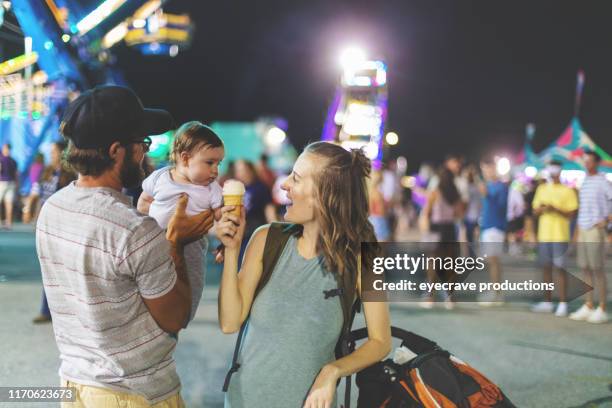 young millennial family enjoying their time at the empire state fair in springfield mo on a hot july summer night - missouri state stock pictures, royalty-free photos & images