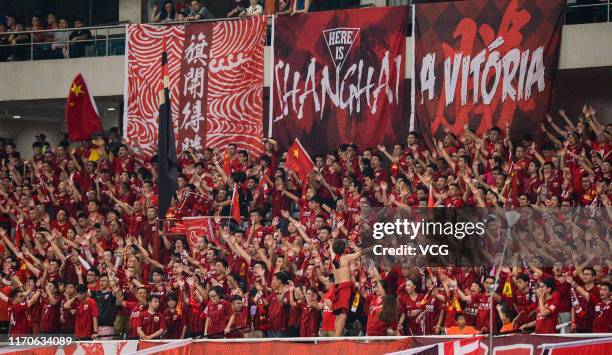 Supporters of Shanghai SIPG cheer during the AFC Champions League quarter-final 1st leg match between Shanghai SIPG and Urawa Red Diamonds at...