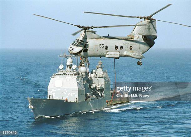 The guided missile cruiser USS Princeton maneuvers during a replenishment operation October 19, 2001 just aft of the aircraft carrier USS Carl...