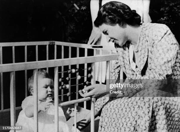 Picture taken on 1949 showing the future Queen Elizabeth II of England with her baby Prince Charles.