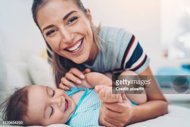 happy mother and baby boy - tickling stock pictures, royalty-free photos & images