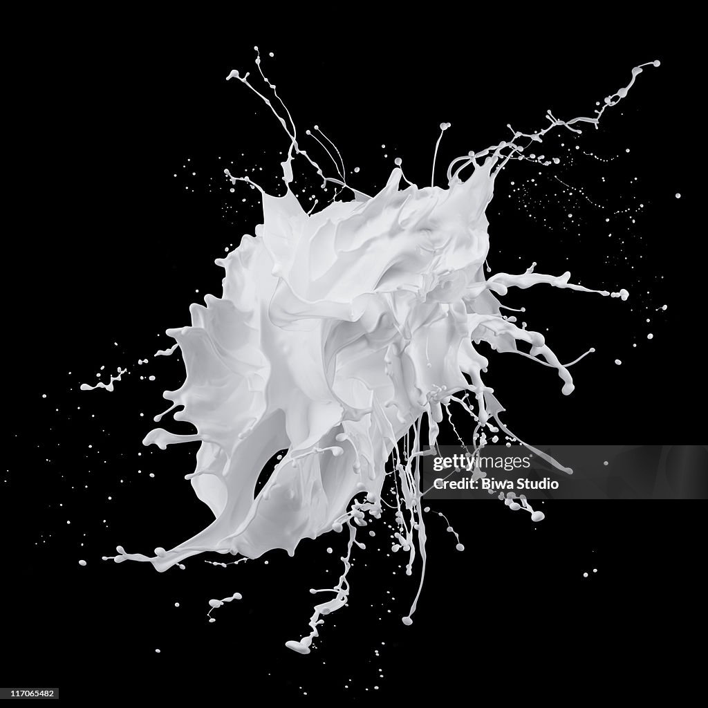 White paint splash on black background