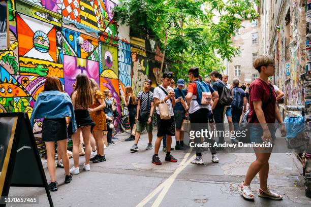 anne frank centre covered with graffiti and street art at hackescher markt. - bar berlin stock pictures, royalty-free photos & images