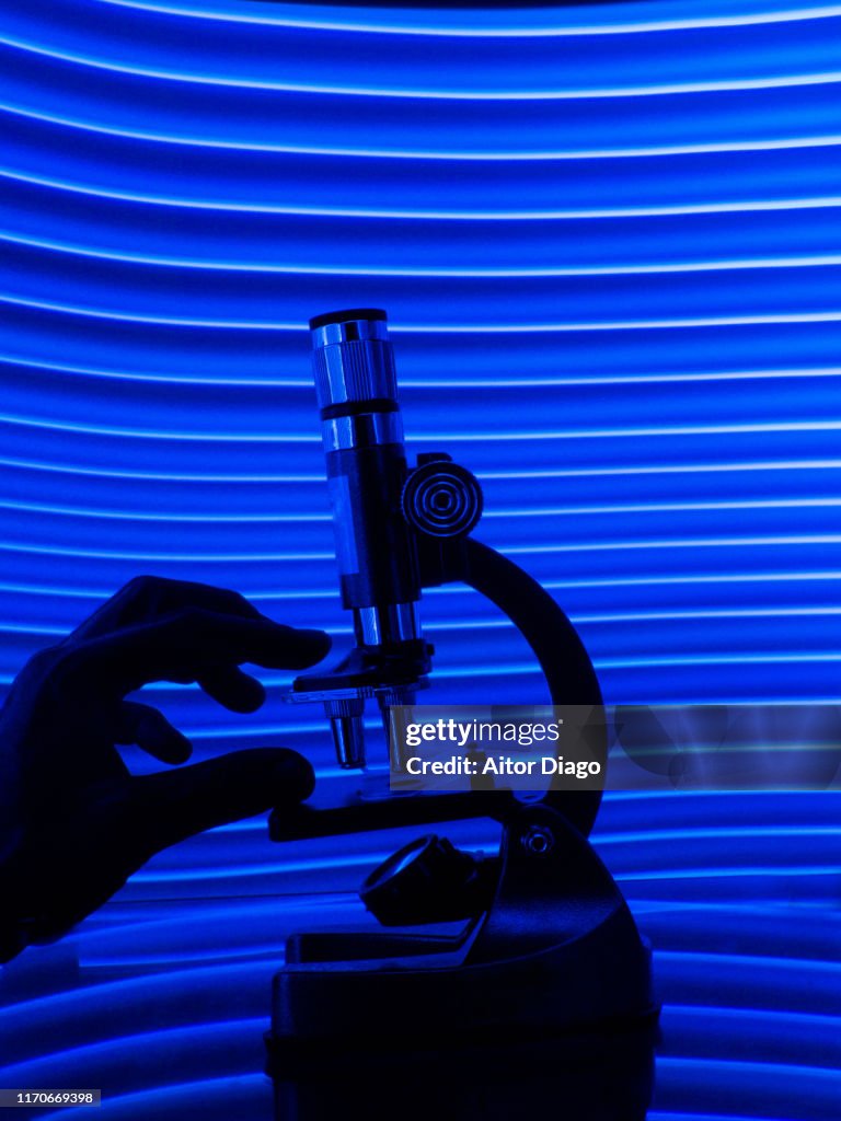 Hand Microscope Background Hand Touching A Microscope In A Futuristic Environment High-Res Stock ...