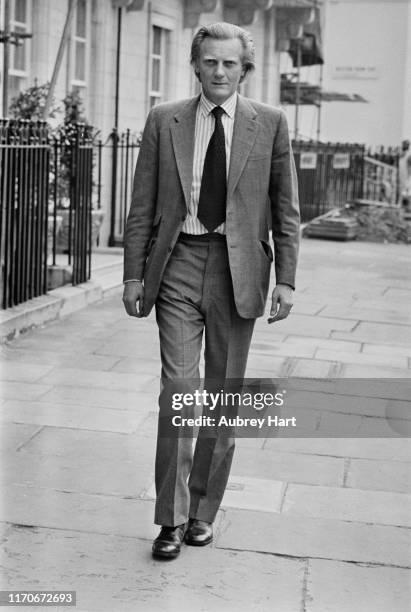 British politician and businessman Michael Heseltine walking down a street, UK, 28th May 1976.