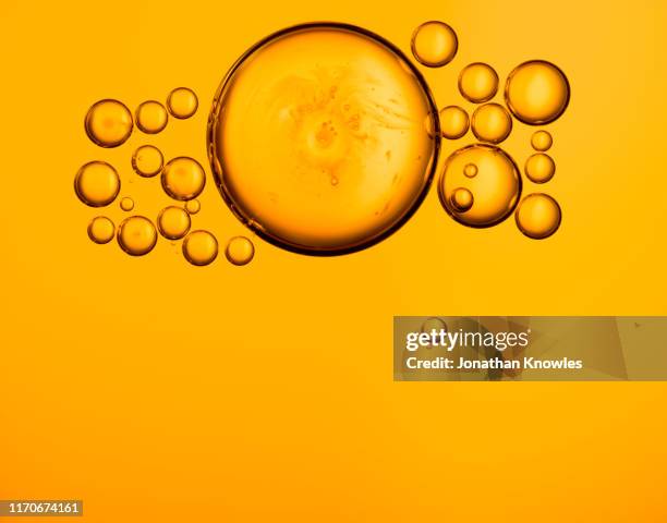 golden oil bubbles - lubrication stock pictures, royalty-free photos & images