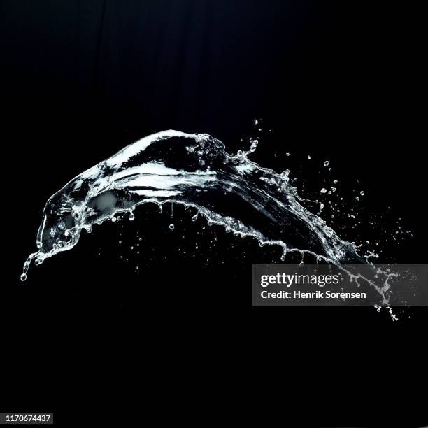 watersplash on black backdrop - water splashing stock pictures, royalty-free photos & images