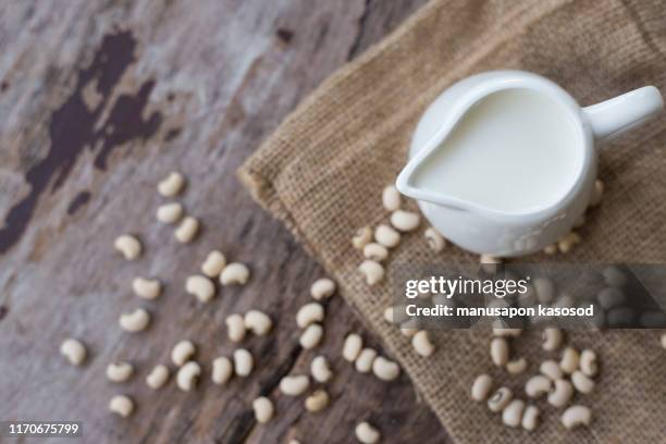 soy milk and soy bean on wooden background - soya milk stock pictures, royalty-free photos & images