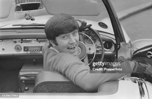 English comedian Jimmy Tarbuck in the driver's seat of his Mercedes 230 SL 2 door coupe car in April 1966.