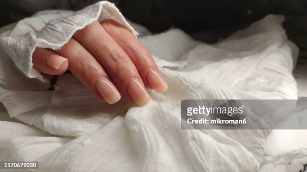 close-up of woman fingers with nail art manicure in nude iii# - huidkleurig stockfoto's en -beelden