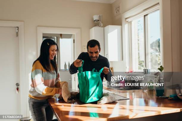 unpacking the groceries - shopping candid stock pictures, royalty-free photos & images