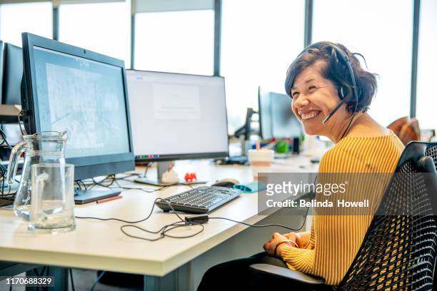 women in an office environment working collaboratively - repicturing disability - disabilitycollection stock pictures, royalty-free photos & images