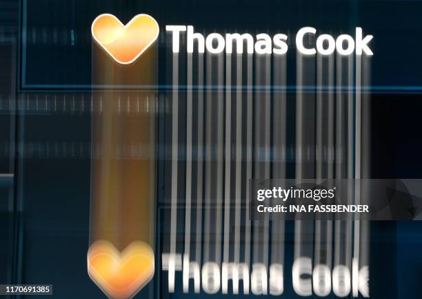 The picture taken with long-exposure time shows the logo of the British travel giant Thomas Cook on September 24, 2019 at the airport in Duesseldorf,...