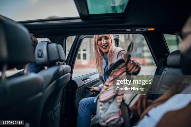hipster woman entering the car - entering car stock pictures, royalty-free photos & images
