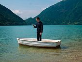 Man in suit on a small boat