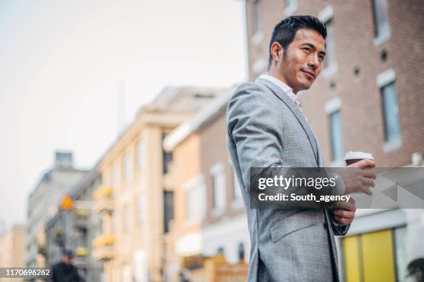 handsome gentleman in suit on the street - asain model men stock pictures, royalty-free photos & images