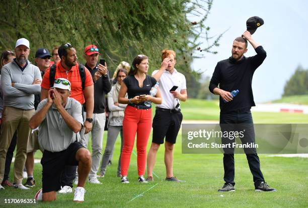 Singer Justin Timberlake of USA ponders a shot during the pro-am prior to the start of the Omega European Masters at Crans Montana Golf Club on...