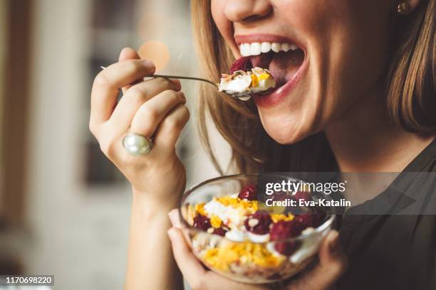 having breakfast - woman eating fruit stock pictures, royalty-free photos & images