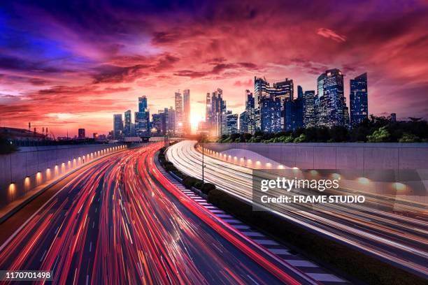 movement car light on singapore road with colourful city light, the car ligth tail move to the city. - singapore cityscape stock pictures, royalty-free photos & images