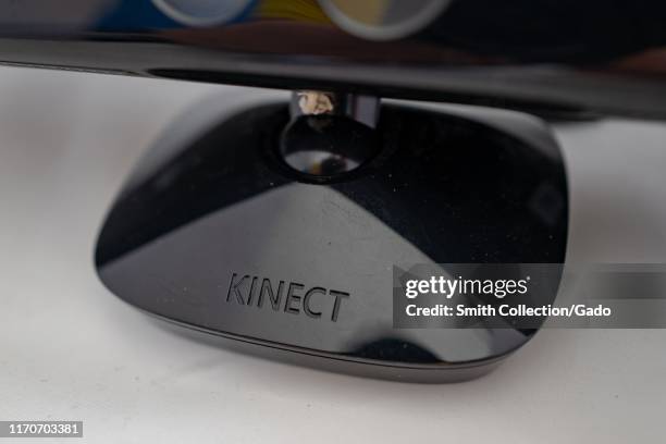 Close-up of logo on base of first generation Xbox 360 Kinect motion sensing gaming controller, a low-cost depth camera designed to allow gesture...