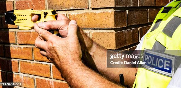 taser gun - taser stock pictures, royalty-free photos & images
