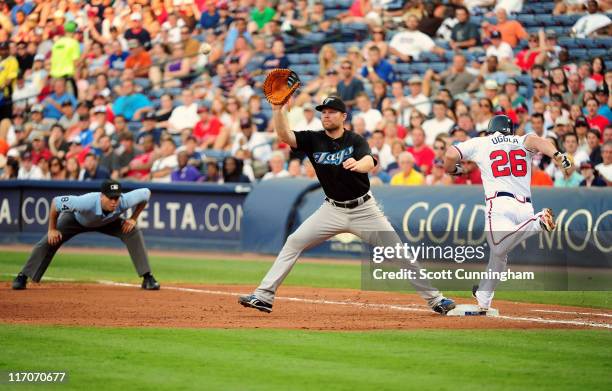 Dan Uggla of the Atlanta Braves beats the throw to first for a hit against the Toronto Blue Jays at Turner Field on June 20, 2011 in Atlanta, Georgia.