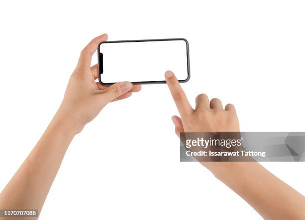 hand holding phone mobile and touching screen isolated on white background - horizontal stock-fotos und bilder