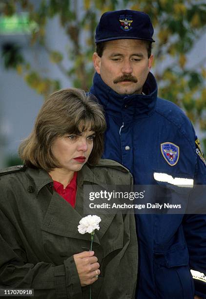 Karen Campbell, and fiance, Jim Foster hold back tears during a wreath hanging for Bonnie Craig at the 9th & G Street Victim's Tree on the Delaney...