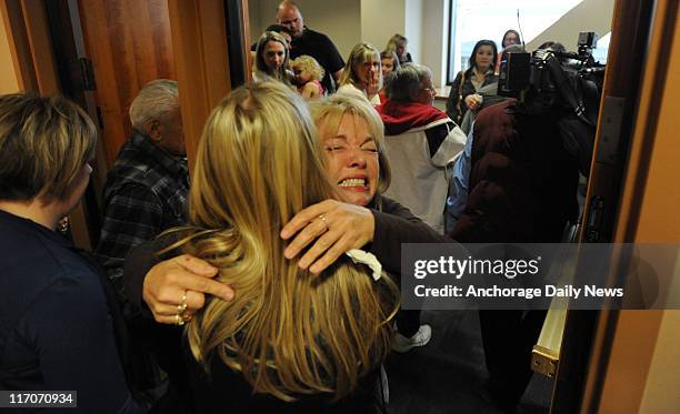 Karen Foster is hugged while leaving a packed Superior Courtroom on June 15 after an Anchorage jury found Kenneth Dion guilty on all counts, of...