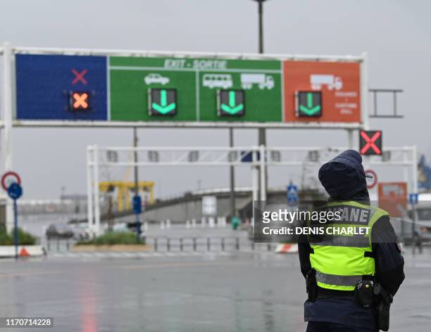 Custom officer stands during a day of test in case of Brexit at the terminal Ferry in Calais, northern France on September 24, 2019. - French customs...