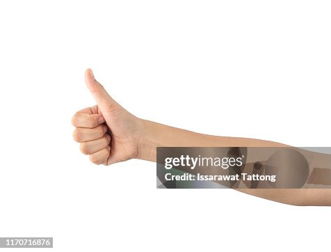 Hand showing thumbs up sign against isolated on white background Hand showing thumbs up sign against isolated on white background