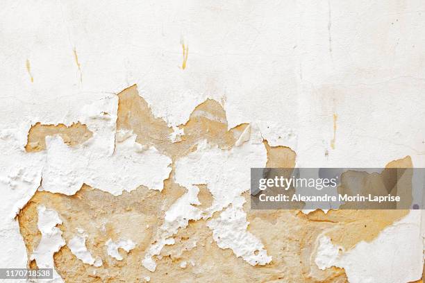 damaged old white paint wall scrapped texture from old building in spain - adobe texture stock pictures, royalty-free photos & images