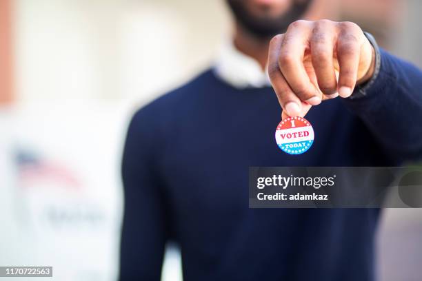 young black man with i voted sticker - vater stock pictures, royalty-free photos & images