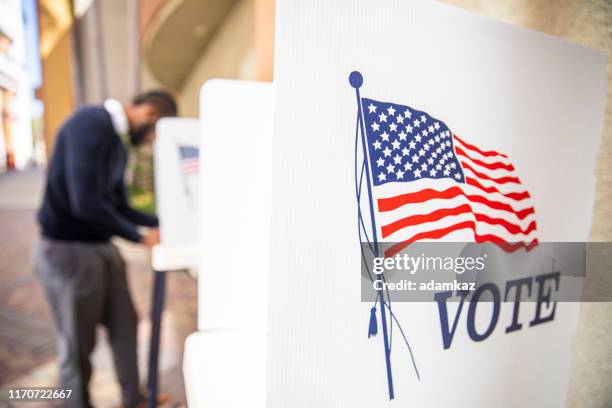 millenial black man voting in election - 2020-election-ballot-box stock pictures, royalty-free photos & images