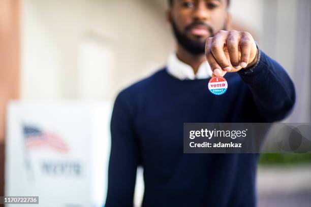 young black man with i voted sticker - vote sticker stock pictures, royalty-free photos & images