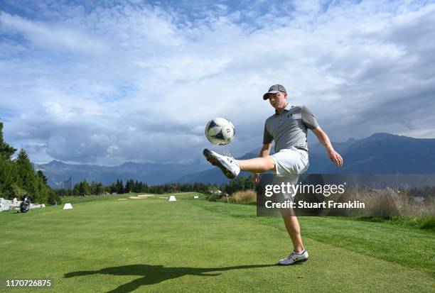 Matt Fizpatrick of England controls a football during the pro-am prior to the start of the Omega European Masters at Crans Montana Golf Club on...