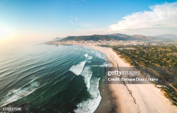 aerial view of waves approaching the pristine coastline at vila praia de âncora, portugal - viana do castelo stockfoto's en -beelden