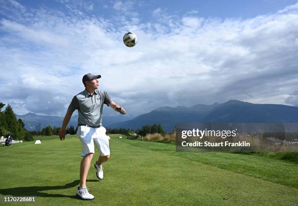 Matt Fitzpatrick of England controls a football during the pro-am prior to the start of the Omega European Masters at Crans Montana Golf Club on...